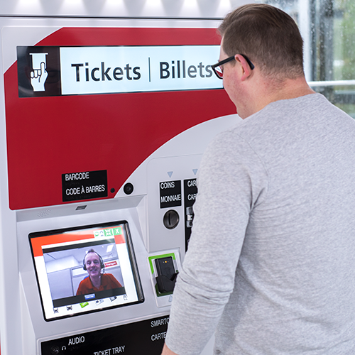 Customer Service Representative speaking with a customer through video chat on a ticket machine.