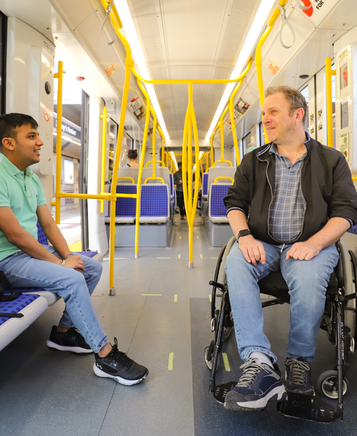 Un usager en situation d'accessibilité à bord du train avec une personne de confiance.